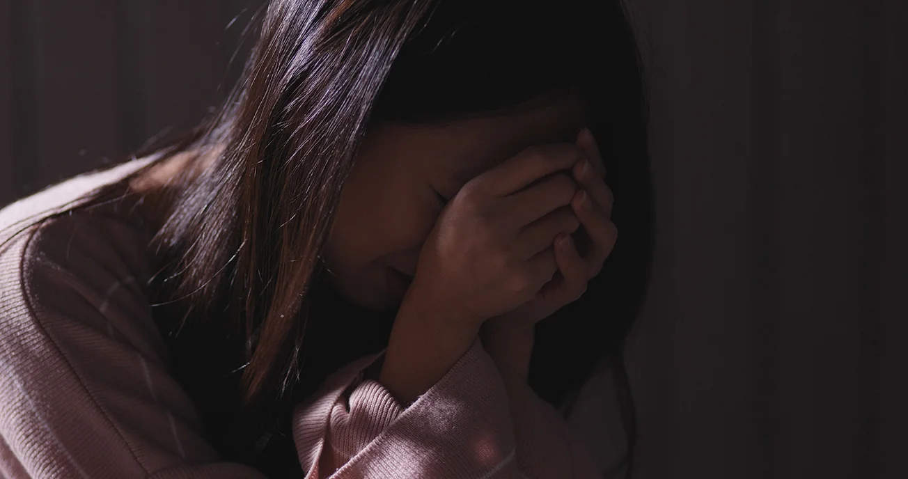 Woman crying in the dark sexual abuse trauma support